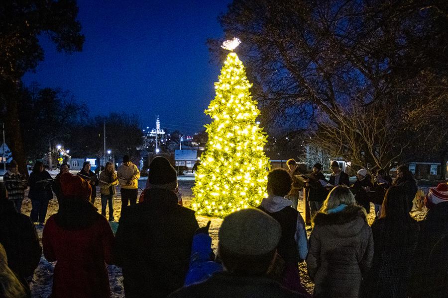 Community members are gathered around a tree during last year's President’s Tree Lighting. (Photo by Lauren Adams/Northwest Missouri State University)